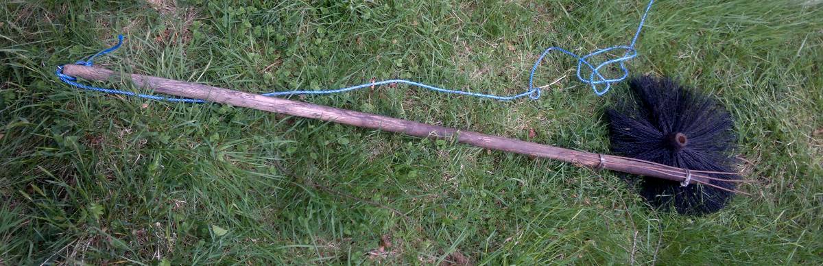 The broken brush and my improvised "trident tool" with safety rope.
